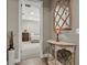 Inviting hallway with unique mirror and decorative console table, leading to a serene bedroom with comfortable furnishings at 645 American Holly Pl, Oviedo, FL 32765