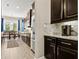 Kitchen with dark wood cabinetry, stainless steel appliances, and granite countertops at 645 American Holly Pl, Oviedo, FL 32765
