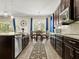 Bright kitchen with dark wood cabinets, stainless steel appliances, and an adjacent dining area at 645 American Holly Pl, Oviedo, FL 32765