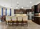 Modern kitchen with stainless steel appliances, granite countertops, island with seating, and dark cabinetry at 645 American Holly Pl, Oviedo, FL 32765