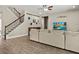 Spacious living room with staircase, comfortable sofa, and entertainment center at 645 American Holly Pl, Oviedo, FL 32765