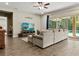 Comfortable living room with large sofa, entertainment center, and sliding glass doors to the pool area at 645 American Holly Pl, Oviedo, FL 32765