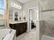 Elegant bathroom features a large soaking tub and shower with stylish fixtures and vanity at 645 American Holly Pl, Oviedo, FL 32765