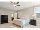 Comfortable main bedroom featuring a ceiling fan, carpet, and views into the ensuite bathroom at 645 American Holly Pl, Oviedo, FL 32765
