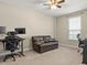 Carpeted office with two work stations and a leather couch at 645 American Holly Pl, Oviedo, FL 32765