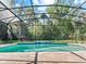 Beautiful pool with a screened enclosure, water feature, and well-maintained brick patio at 645 American Holly Pl, Oviedo, FL 32765