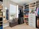 Spacious walk-in closet featuring custom shelving, bench, and natural light at 645 American Holly Pl, Oviedo, FL 32765