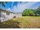 Home features a large grassy backyard with a view of the back and side exteriors, well-suited for outdoor activities at 73 Channing Ave, Orlando, FL 32811