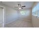 Bedroom features tile flooring, a ceiling fan, two windows and freshly painted walls at 73 Channing Ave, Orlando, FL 32811