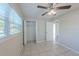 Bedroom features tiled floor, ceiling fan and closet space in a naturally lit room at 73 Channing Ave, Orlando, FL 32811