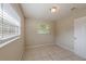 Bedroom featuring tile flooring, fresh paint and a sunny window at 73 Channing Ave, Orlando, FL 32811