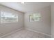 Bedroom features tile flooring and two sunny windows with horizontal blinds at 73 Channing Ave, Orlando, FL 32811