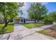 Charming single-story home with a well-manicured lawn and a concrete driveway and walkway at 73 Channing Ave, Orlando, FL 32811