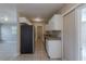 Galley kitchen featuring white cabinets, granite countertops, and stainless steel appliances at 73 Channing Ave, Orlando, FL 32811