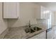 Well-maintained kitchen with a stainless steel sink and granite countertops at 73 Channing Ave, Orlando, FL 32811