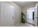 Utility room featuring tile flooring, water heater and white painted brick walls at 73 Channing Ave, Orlando, FL 32811
