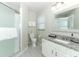 Bathroom featuring vanity with granite countertop, modern fixtures, and glass-enclosed shower at 7834 Turkey Oak Ln, Kissimmee, FL 34747