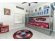 Bedroom with themed bunk beds, decorated with colorful superhero decor, fan, and window at 7834 Turkey Oak Ln, Kissimmee, FL 34747