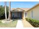Charming front entrance with cozy screened porch, manicured landscaping, and a freshly painted walkway at 7834 Turkey Oak Ln, Kissimmee, FL 34747