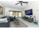 Inviting living room with comfortable seating, a large TV, and sliding glass doors offering pool views at 7834 Turkey Oak Ln, Kissimmee, FL 34747