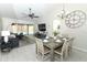 Open-concept living space combines dining area and living room with sliding glass doors to a swimming pool at 7834 Turkey Oak Ln, Kissimmee, FL 34747
