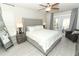 Main bedroom features neutral tones, a king-sized bed, and access to a private outdoor patio at 7834 Turkey Oak Ln, Kissimmee, FL 34747