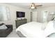 Cozy bedroom features a large dresser, television, and ensuite access to a bathroom at 7834 Turkey Oak Ln, Kissimmee, FL 34747