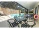 Backyard with outdoor seating, barbecue, and refreshing pool, all within a screened enclosure at 7834 Turkey Oak Ln, Kissimmee, FL 34747