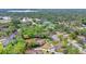 Aerial view of the community with mature trees, private pools, tennis courts, and scenic surroundings at 801 Fox Valley Dr, Longwood, FL 32779