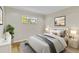 Comfortable bedroom with neutral walls, wood floors, and large window with serene outdoor views at 801 Fox Valley Dr, Longwood, FL 32779