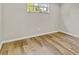 Bright, empty bedroom with wood-look flooring and a window providing natural light at 801 Fox Valley Dr, Longwood, FL 32779