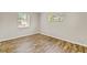 Bright, empty bedroom with wood-look flooring and two windows providing natural light at 801 Fox Valley Dr, Longwood, FL 32779