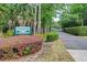 View of the gated community entrance to Riverbend Park with lush landscaping and mature trees at 801 Fox Valley Dr, Longwood, FL 32779