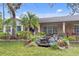 Charming home with a brick facade, a small waterfall feature, blue shutters, and lush landscaping at 801 Fox Valley Dr, Longwood, FL 32779