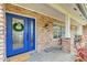 Charming front porch with brick accents, a blue door, and lovely curb appeal at 801 Fox Valley Dr, Longwood, FL 32779