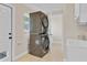 Functional laundry room featuring a stacked washer and dryer and utility sink at 801 Fox Valley Dr, Longwood, FL 32779