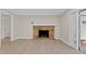Cozy living room featuring a classic brick fireplace and access to an outdoor patio at 801 Fox Valley Dr, Longwood, FL 32779