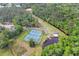 Aerial view of community tennis courts and canoes by the lake, surrounded by mature trees at 801 Fox Valley Dr, Longwood, FL 32779