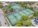 Aerial view of the community tennis courts, surrounded by lush greenery and parking at 801 Fox Valley Dr, Longwood, FL 32779