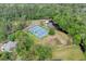 Aerial view of the tennis courts by the lake, surrounded by mature trees in a gated community at 801 Fox Valley Dr, Longwood, FL 32779