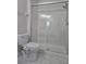Bathroom featuring new toilet, and new glass shower doors at 8775 Sartori St # 302, Orlando, FL 32829