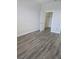 Spacious bedroom featuring wood-look flooring and ample closet space at 8775 Sartori St # 302, Orlando, FL 32829