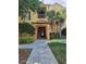Exterior view of the condo complex with landscaping and walkway at 8775 Sartori St # 302, Orlando, FL 32829