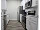 Modern kitchen with stainless steel appliances and white cabinets at 8775 Sartori St # 302, Orlando, FL 32829