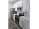 Kitchen with white cabinets, marble countertops, and stainless steel appliances at 8775 Sartori St # 302, Orlando, FL 32829