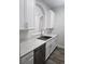 Kitchen sink with white cabinets, marble countertops, and stainless steel appliances at 8775 Sartori St # 302, Orlando, FL 32829