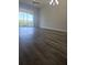 Bright living room featuring modern flooring and a sliding glass door to the balcony for natural light at 8775 Sartori St # 302, Orlando, FL 32829