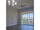 Bright living room featuring a ceiling fan and sliding glass door to balcony for natural light at 8775 Sartori St # 302, Orlando, FL 32829