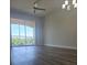 Living room with ceiling fan and slider to balcony at 8775 Sartori St # 302, Orlando, FL 32829