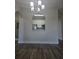 Living room with wood look floors and view of the kitchen at 8775 Sartori St # 302, Orlando, FL 32829
